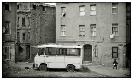 Photo for Parked white bus near old budiling - Royalty Free Image
