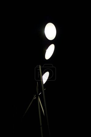 Photo for Three Bright Spotlights Against Black - Royalty Free Image