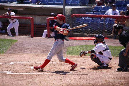 Photo for "Reading Phillies Tim Kennelly takes a big swing". Baseball Game Concept - Royalty Free Image