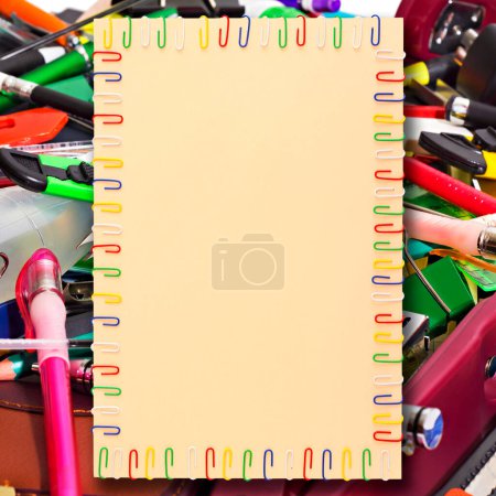 Photo for Sheet of paper in a frame of colored paper clips in the background - Royalty Free Image