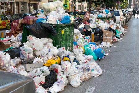 Photo for Piles of garbage on the streets due to fulls garbage bins. Incivility, rudeness and dirt. Bergamo, ITALY - October 15, 2018 - Royalty Free Image