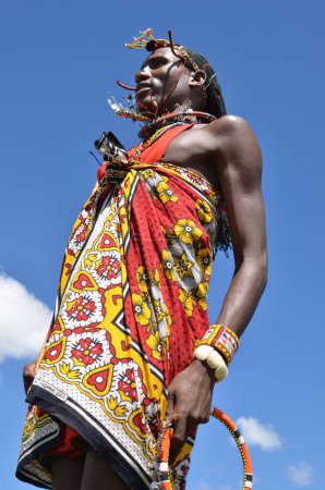 Photo for Maasai Mara men in traditional colorful clothing showing traditional Maasai jumping dance at Maasai Mara tribe village famous Safari travel destination near Maasai Mara National Reserve Kenya - Royalty Free Image