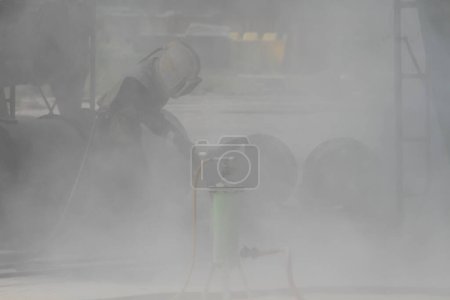 Photo for Sandblasting of metal structures at construction site - Royalty Free Image
