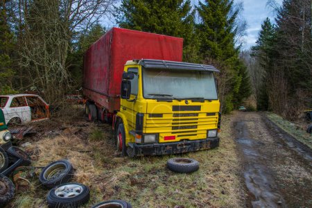 Photo for Scrapyard for cars (yellow truck) on background - Royalty Free Image