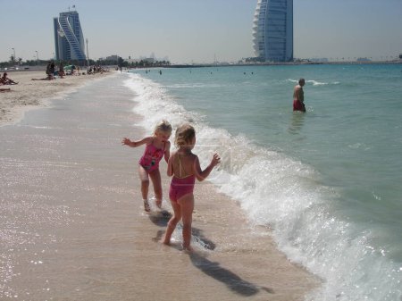 Photo for Scandinavian Lifestyle-girls playing on the beach of Dubai - Royalty Free Image
