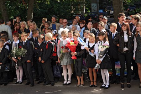 Photo for School children standing on the street with parents - Royalty Free Image