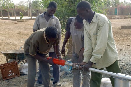 Téléchargez les photos : Montage d'une pompe au Burkina Faso - en image libre de droit