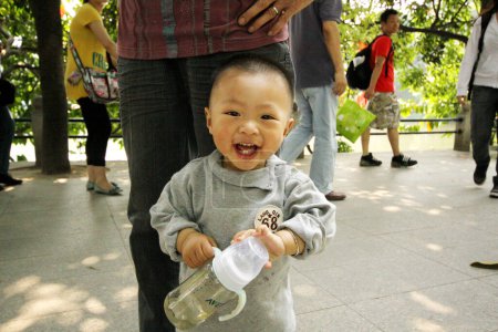 Photo for A happy child in park of Guangzhou, China - Royalty Free Image