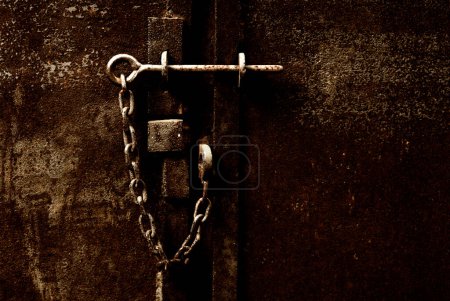 Photo for Rusty metal lock on a chain on old door - Royalty Free Image