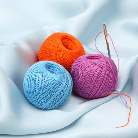 Photo for Knitting yarn with needles, orange and blue - Royalty Free Image