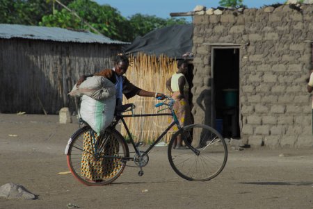 Photo for African woman riding a bicycle - Royalty Free Image