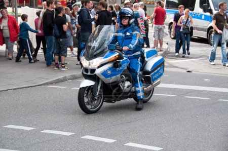 Photo for Policeman on motorbike on city streets - Royalty Free Image