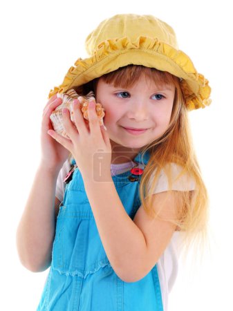 Photo for Small girl listens a sea shell - Royalty Free Image