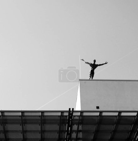 Photo for Statue jumping from the building - Royalty Free Image