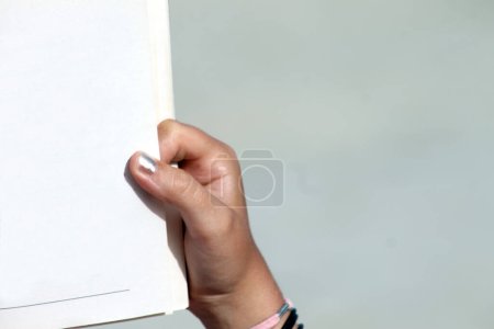 Photo for Hand turning pages of book - Royalty Free Image