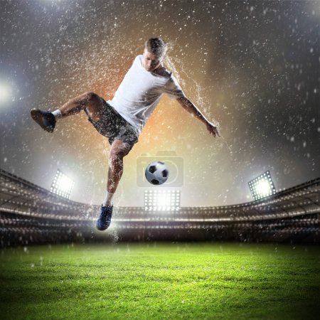 Photo for Young Football player with ball on stadium - Royalty Free Image