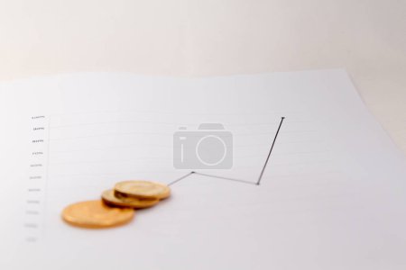Photo for Gold coins on financial charts - Royalty Free Image