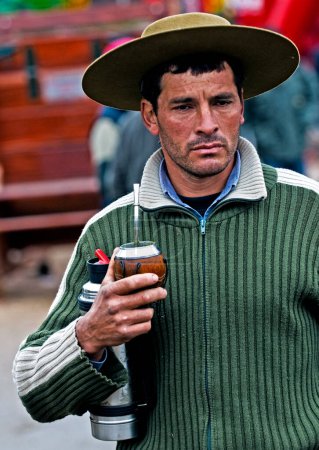 Photo for Gaucho man with cowboy hat drinking tea - Royalty Free Image
