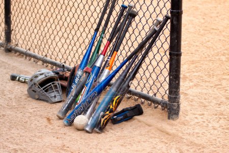 Photo for "Baseball bats and fence.". Baseball Game Concept - Royalty Free Image