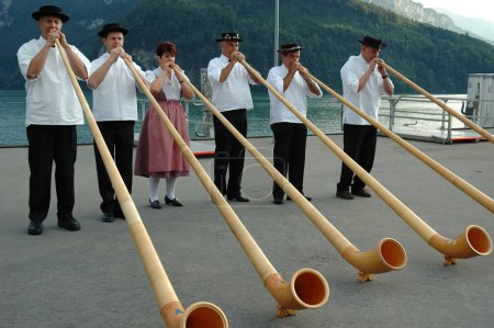 Photo for Alphorn traditional representation, folk music ensemble - Royalty Free Image