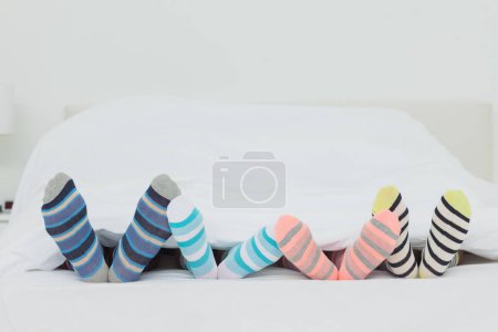 Photo for Familys feet in stripey socks - Royalty Free Image