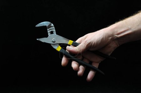 Photo for Pliers and a Hand - Royalty Free Image