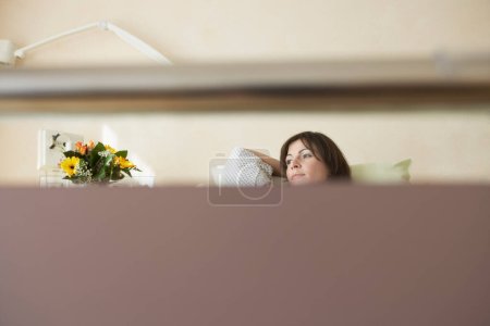 Photo for View of a female patient resting in hospital bed through bed handle - Royalty Free Image