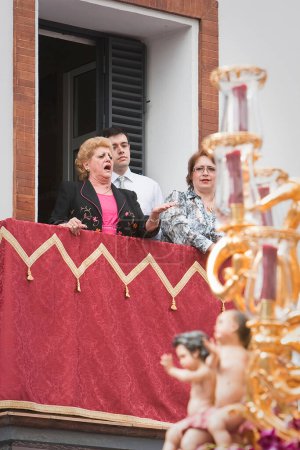 Foto de Saetera cantando desde un balcón en el barrio de Triana durante la procesión en santo lunes, Sevilla, Andalucía, España - Imagen libre de derechos