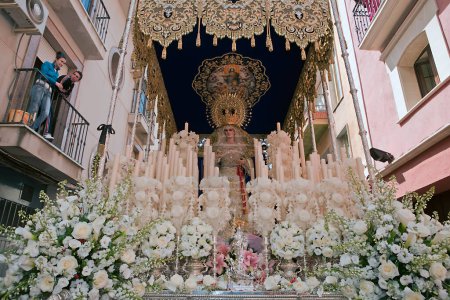 Photo for Front with candles, embroidered fabric and flowers of the throne of the Nuestra Seora del Amor Hermoso, Linares, Jaen province, Spain - Royalty Free Image