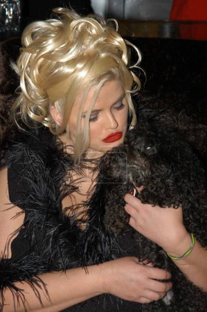 Photo for American model Anna Nicole Smith holding black dog, West Hollywood, CA, United States - Royalty Free Image