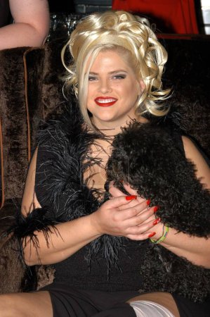 Photo for American model Anna Nicole Smith smiling and holding black dog, West Hollywood, CA, United States - Royalty Free Image