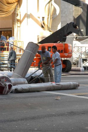 Photo for Work Crews break down the Oscar red carpet area after arrivals were cancelled due to the impending war at the Kodak Theater, where the arrivals area for the 2003 Oscars is taken down, Hollywood, CA 03-19-03 - Royalty Free Image