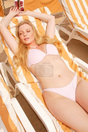 Photo for Gry Wernberg Bay sunbathing on beach sun lounger at Cannes, France 05.15.04 - Royalty Free Image