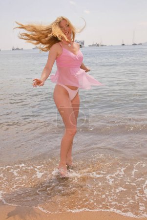 Photo for Gry Wernberg Bay wearing bikini with pink top and posing on beach at Cannes, France 05.15.04 - Royalty Free Image