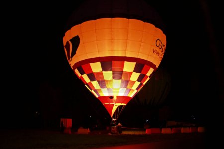 Photo for Hot air baloon starting to fly in the evening sky - Royalty Free Image