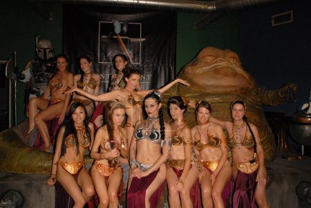 Photo for Eliot Sirota, Adrianne Curry, Shae Strandefer, Victoria, Anna Kay Akana, Paula Labaredas, Alicia Arden, Annisse, Natalie Atkins, Jill Franklin and Bridget Lane Parksat the Slave Leia day tour and photo shoot with Jabba the Hutt, - Royalty Free Image