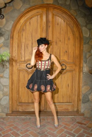 Photo for Phoebe Price wearing dress with hat on set of 'Paradise Cove'. actress posing at wooden door Private Location, Malibu - Royalty Free Image