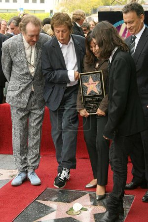 Photo for L-R Eric Idle, Sir Paul McCartney, Olivia Harrison, Dhani Harrison and Tom Hanksat the ceremony posthumously honoring George Harrison with a star on the Hollywood Walk of Fame. Vine Boulevard, Hollywood, CA. 04-14-09 - Royalty Free Image