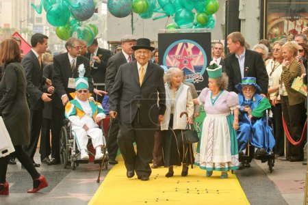 Photo for Johnny Grant with the actors who played The Munchkins From The Wizard of OZ at a ceremony honoring the Munchkins with a star on the Hollywood Walk of Fame. Hollywood Boulevard, Hollywood, CA. - Royalty Free Image