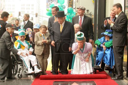 Photo for Johnny Grant with the actors who played The Munchkins From "The Wizard of OZ" at a ceremony honoring the Munchkins with a star on the Hollywood Walk of Fame. Hollywood Boulevard, Hollywood, CA. - Royalty Free Image