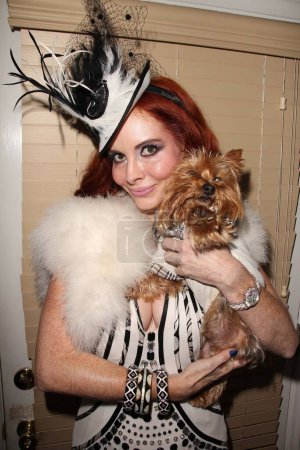 Photo for Phoebe Price holding cute puppy wearing white dress and hat while preparing for American Music Awards, Private Location, Los Angeles, CA 11-20-11 - Royalty Free Image