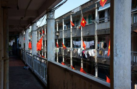 Photo for Vietnamese flags on the flat block buildings - Royalty Free Image