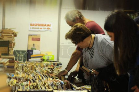 Photo for SERBIA, BELGRADE - OCTOBER 27, 2012: People choosing books at the International Belgrade Book Fair - Royalty Free Image