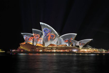 Photo for Sydney Opera House with multicolor illuminated projection at night, famous Australian architecture - Royalty Free Image