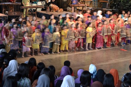 Photo for Bandung, indonesia-june 16, 2014: kids playing angklung at saung angklung udjo. angklung is traditional musical heritage made from bamboo and worldwide recognize originally from indonesia. - Royalty Free Image