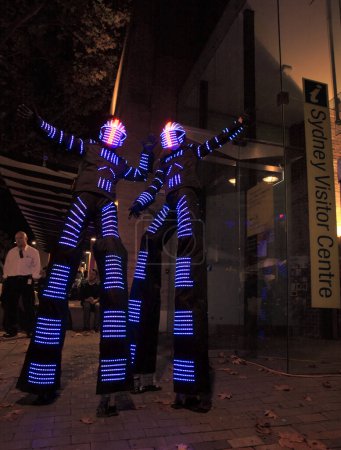 Photo for Illuminated street performers,  stilt walkers for Sydney Visitor Center - Royalty Free Image