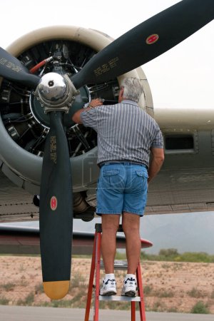 Photo for Man standing near WWII B-17 Bomber Engine - Royalty Free Image