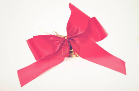 Photo for Red satin ribbon and golden bell with retro filter effect - Royalty Free Image