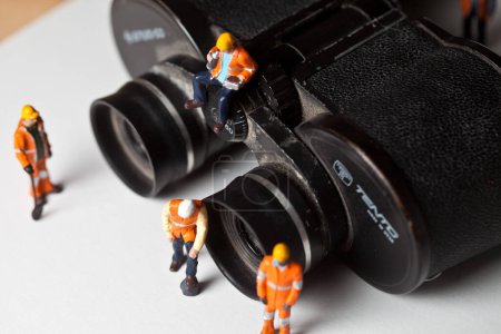 Photo for Miniature people in action with magnification glasses - Royalty Free Image