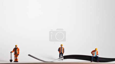 Photo for Miniature people in action worker on a fork - Royalty Free Image